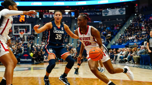Nov 20, 2022; Hartford, Connecticut, USA; North Carolina State Wolfpack guard Saniya Rivers (22) dribbles the ball past Connecticut Huskies guard Azzi Fudd (35) during the first half at XL Center.
